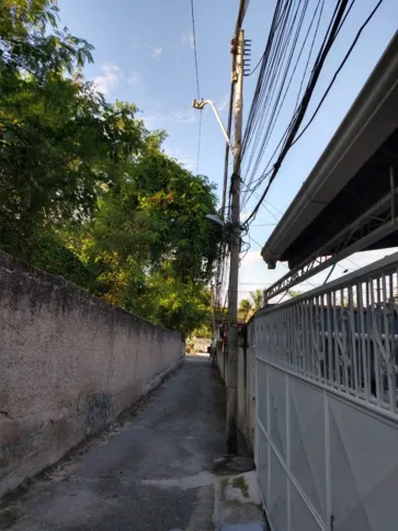 Anteriormente, um dos galhos de uma planta do terreno vizinho estava sobre os fios de luz da travessa