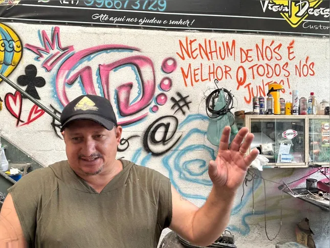 Charles Melo de Almeida, idealizador do "Pé de Pão", pendura pessoalmente os saquinhos de pão todas as manhãs em uma árvore na Rua Pio Borges