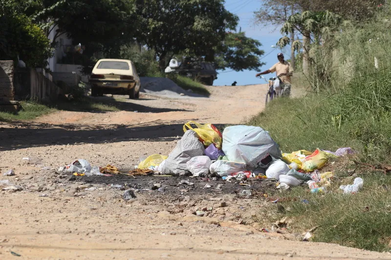 O lixo é amontoado no meio da rua, causando mau cheiro e atraindo moscas, para desespero dos moradores, que temem doenças