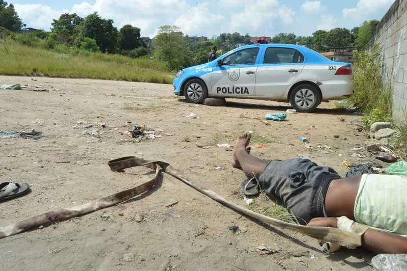 Policiais militares fazem a guarda de uma das vítimas, encontrada na Estrada Nazário Machado