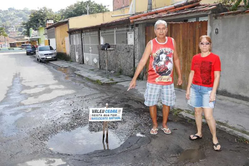 Moradores fizeram placa para chamar atenção da Cedae para o conserto do vazamento d’água