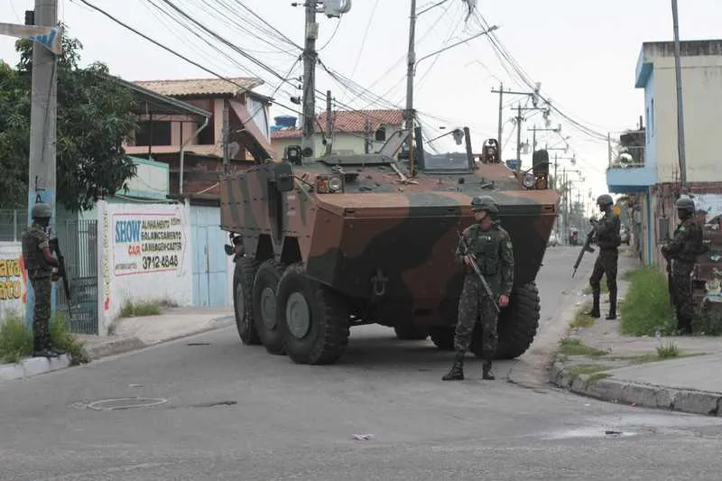 Integrantes das Forças Armadas circularam por várias ruas do bairro a bordo de caminhões e blindados, fazendo a varredura e desobstrução das vias bloqueadas por barricadas instaladas pelo tráfico