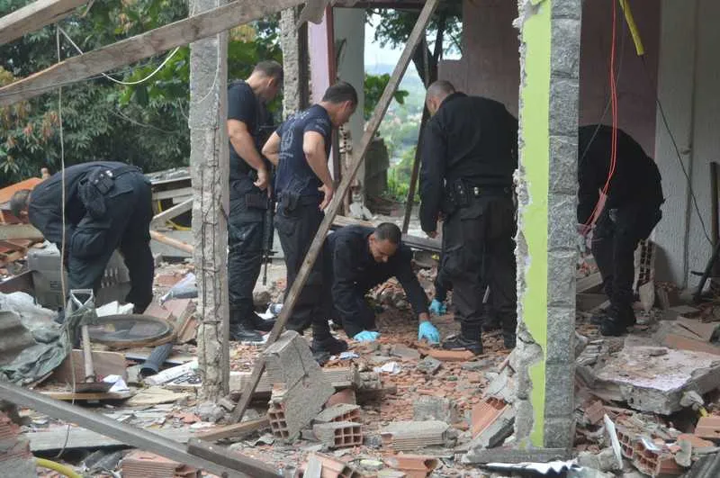  A casa foi destruída pela explosão. Os policiais estão investigando a possibilidade de dinamite ter sido usada no atentado